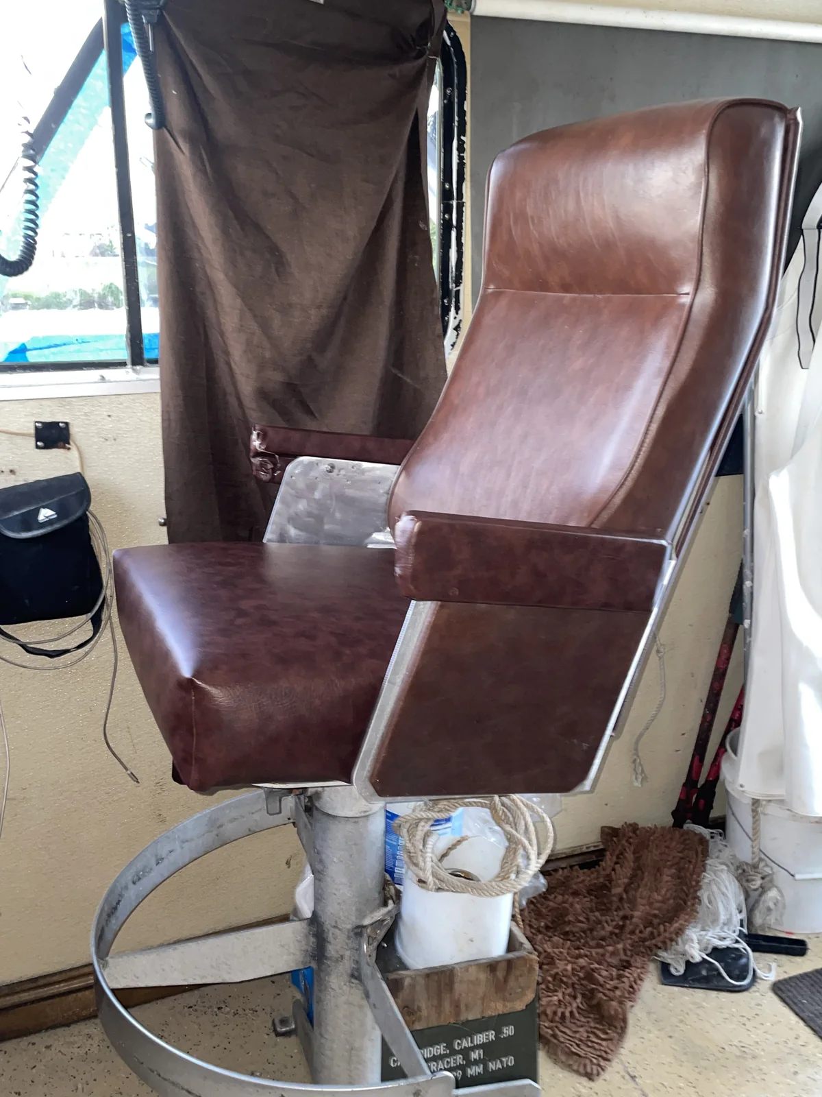 Restored brown marine captain’s chair aboard a working boat